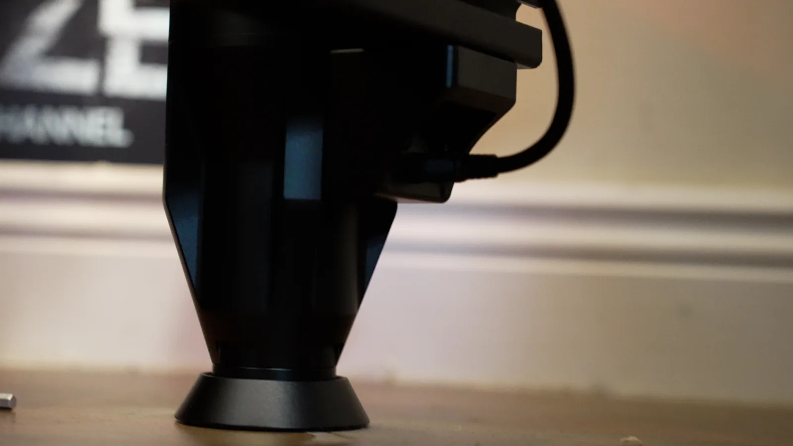 The foot of a Circuit One D Force 1 actuator on a wooden floor, cable running up to the rig