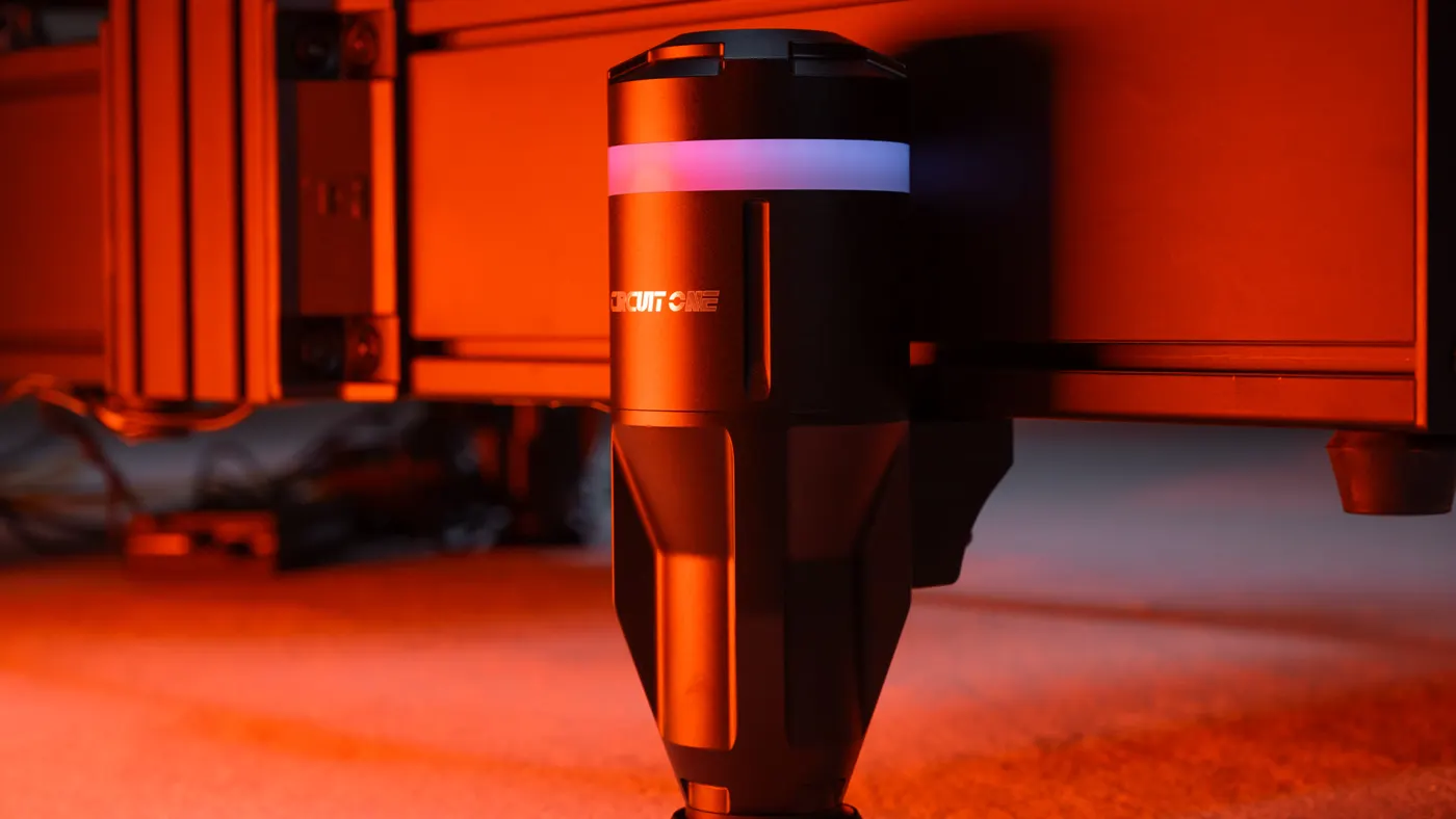 A Circuit One D Force 1 actuator bolted under an aluminium profile rig, light ring lit