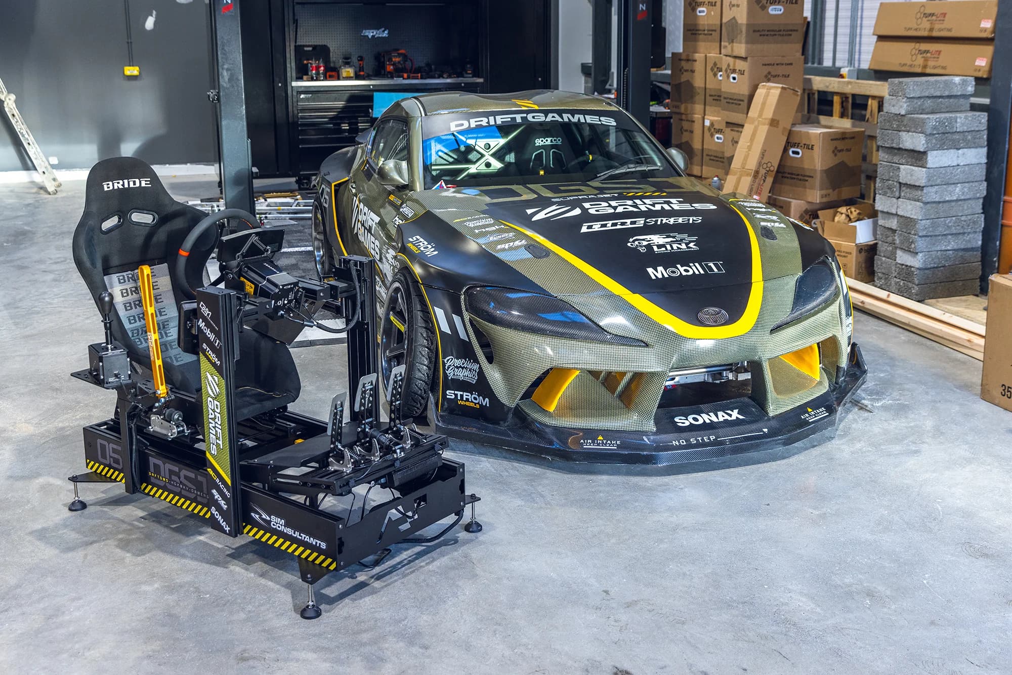 Custom rig alongside a Drift Games Toyota Supra